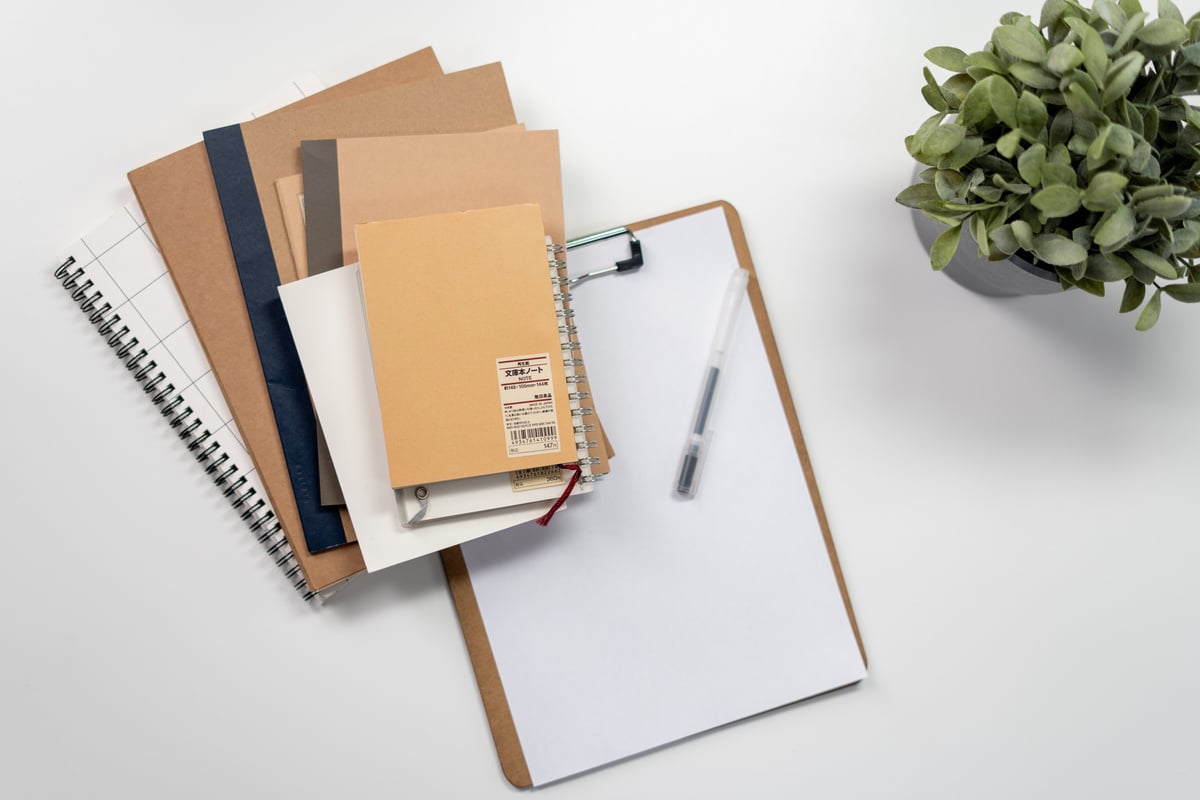 Brown Folder With Black Pen on White Table