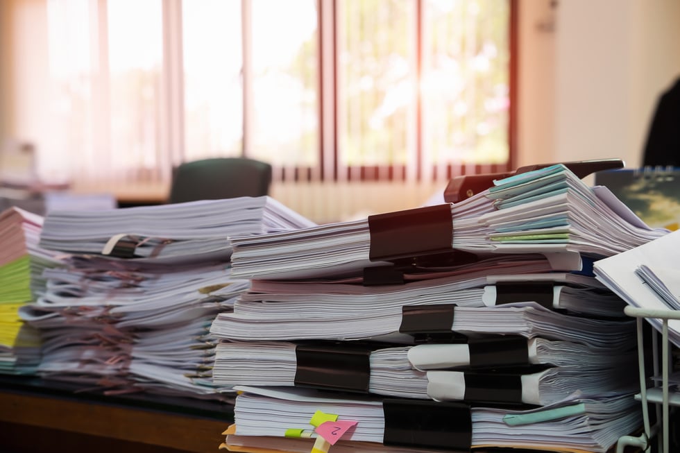 Close Up of Bundled and Stacked Documents on Table